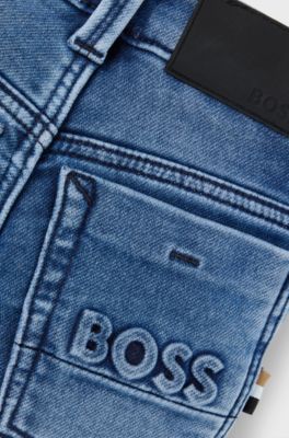 Jeans per bambini in denim elasticizzato con tasca posteriore brandizzata, A disegni
