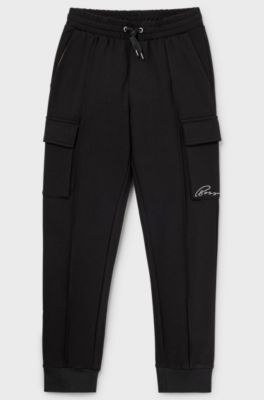 Kids' tracksuit bottoms with cargo pockets, Black
