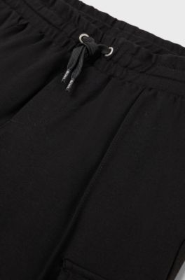 Kids' tracksuit bottoms with cargo pockets, Black