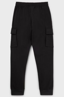 Kids' tracksuit bottoms with cargo pockets, Black