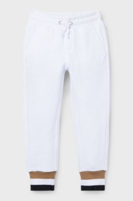 Pantalones de ch&aacute;ndal para ni&ntilde;os en algod&oacute;n con rayas de la marca en los pu&ntilde;os, Blanco