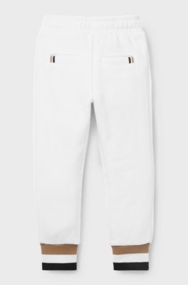 Pantalones de ch&aacute;ndal para ni&ntilde;os en algod&oacute;n con rayas de la marca en los pu&ntilde;os, Blanco