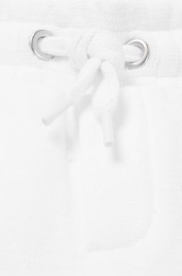 Kids' tracksuit bottoms in cotton with signature-stripe cuffs, White