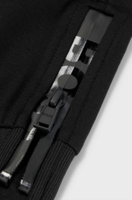 Kids' cargo trousers with zipped hems and striped label, Black