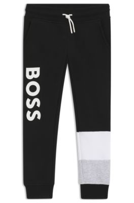 Kids' tracksuit bottoms with colour-blocking and logo print, Black