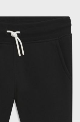 Kids' tracksuit bottoms with colour-blocking and logo print, Black