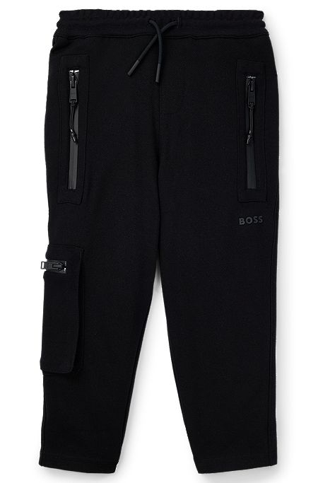 Kids' tracksuit bottoms in stretch piqué with patch pocket, Black
