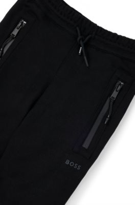 Kids' tracksuit bottoms in stretch piqu&eacute; with patch pocket, Black