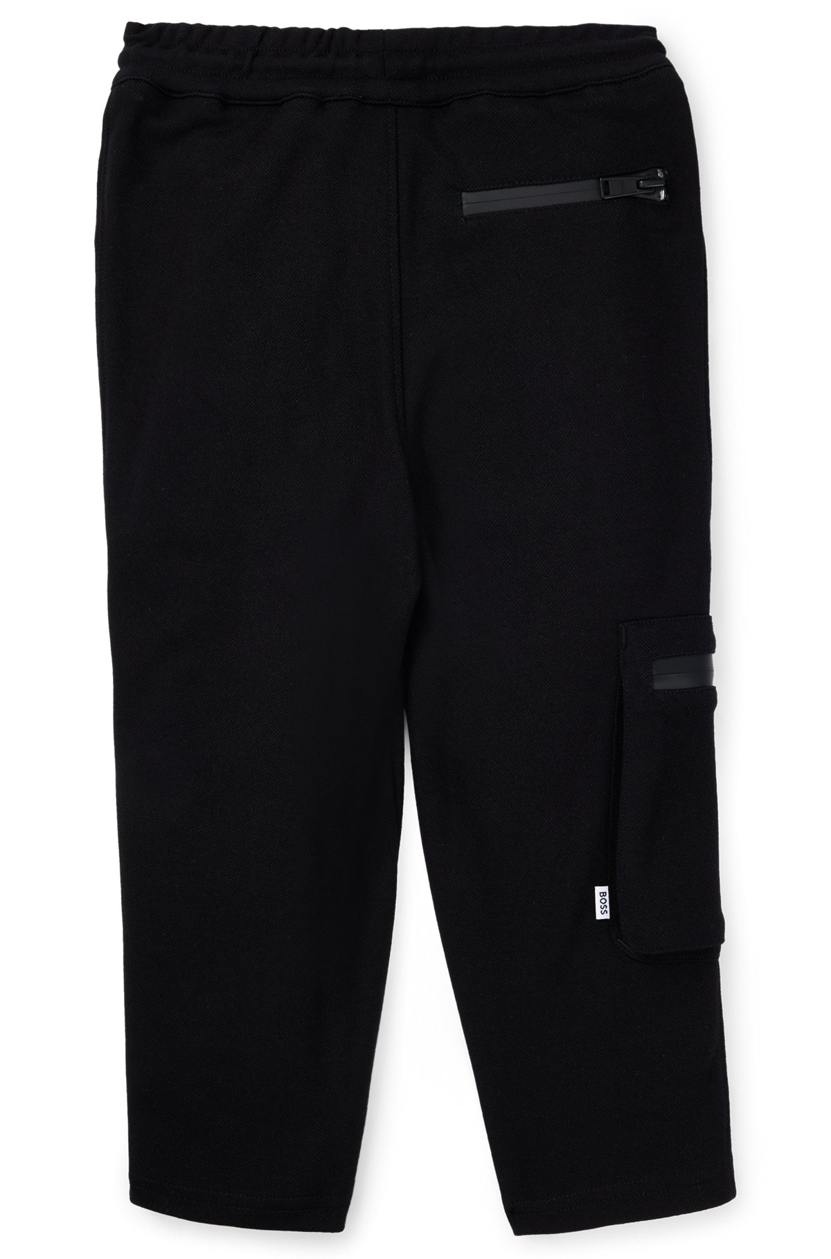 Kids' tracksuit bottoms in stretch piqué with patch pocket, Black
