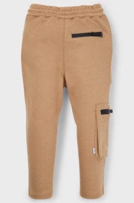 Kids' tracksuit bottoms in stretch piqu&eacute; with patch pocket, Brown