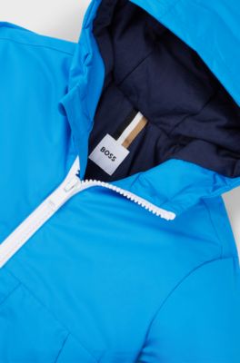 Giacca a vento con cappuccio per bambini che rivela un motivo con monogrammi, Blu