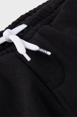 Kids' fleece tracksuit bottoms with logo print, Black