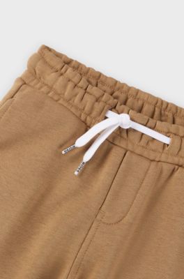 Kids' fleece tracksuit bottoms with logo print, Brown