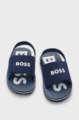 Kids' slides with ankle strap and branding, Dark Blue