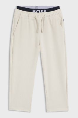 Kids' loose-fit tracksuit bottoms in stretch velvet, Light Beige