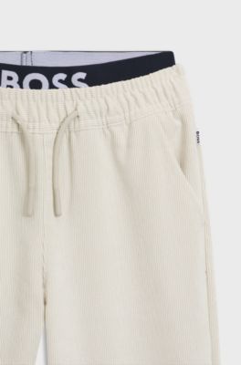 Kids' loose-fit tracksuit bottoms in stretch velvet, Light Beige