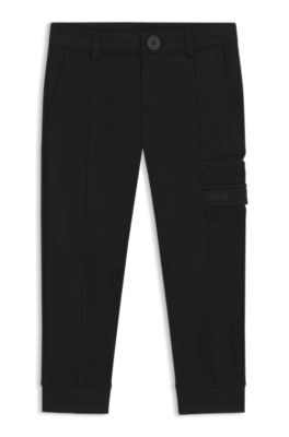 Tracksuit-byxor f&ouml;r barn i pik&eacute; med stretch och tryckt logga, Svart