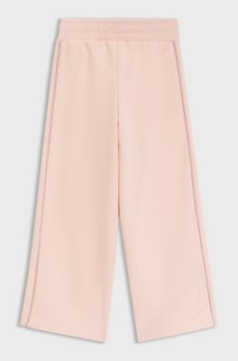 Kids' tracksuit bottoms with logo plaque, light pink