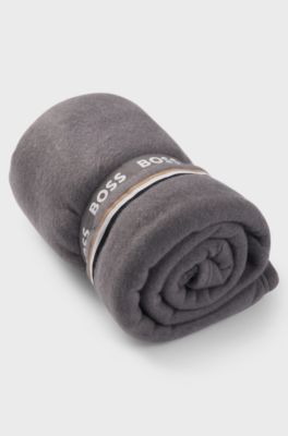 Fleece throw with signature-stripe ribbon, Grey