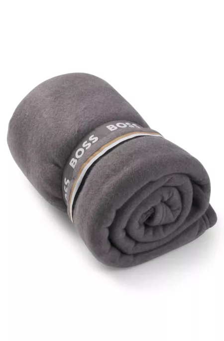Fleece throw with signature-stripe appliqué
