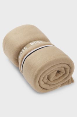 Fleece throw with signature-stripe ribbon, Beige