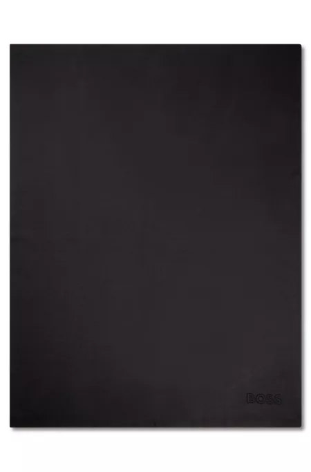 Knitted throw with embroidered logo