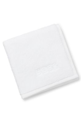 Cotton face cloth with contrast embroidered logo, White