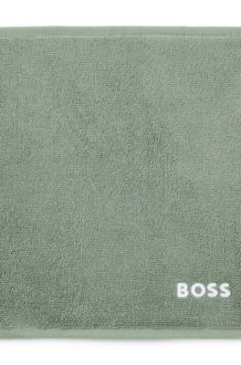 Cotton face cloth with contrast embroidered logo 1