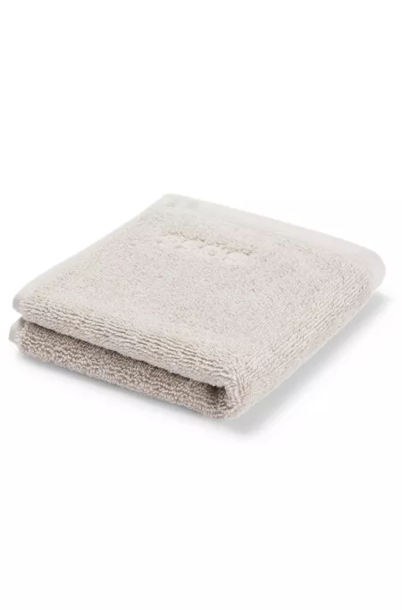 Aegean-cotton face cloth with tonal logo