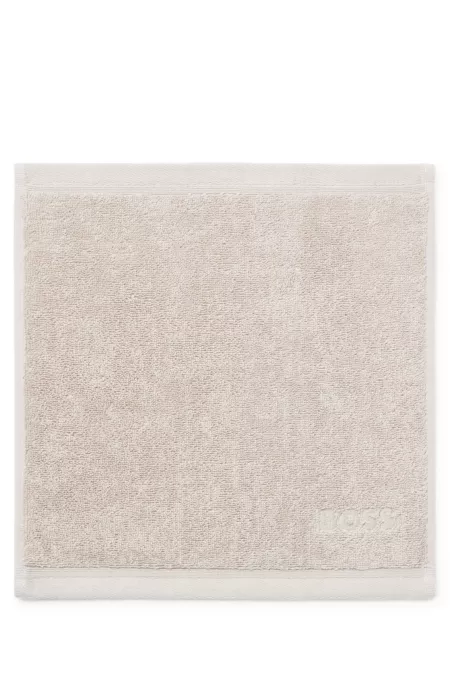Aegean-cotton face cloth with tonal logo