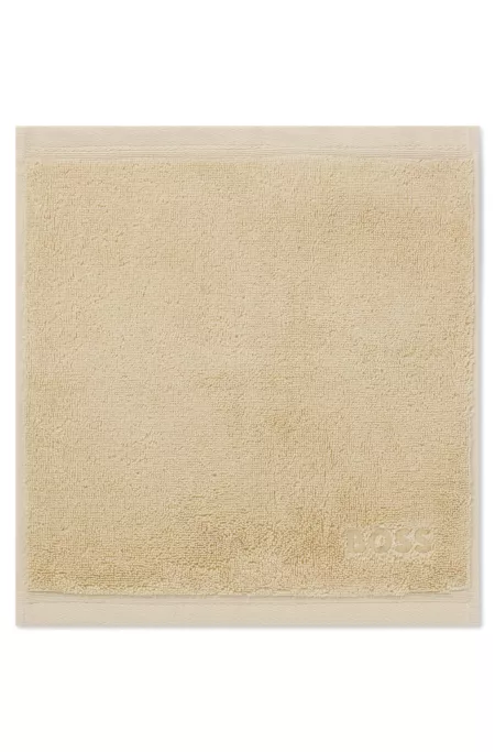 Aegean-cotton face cloth with tonal logo