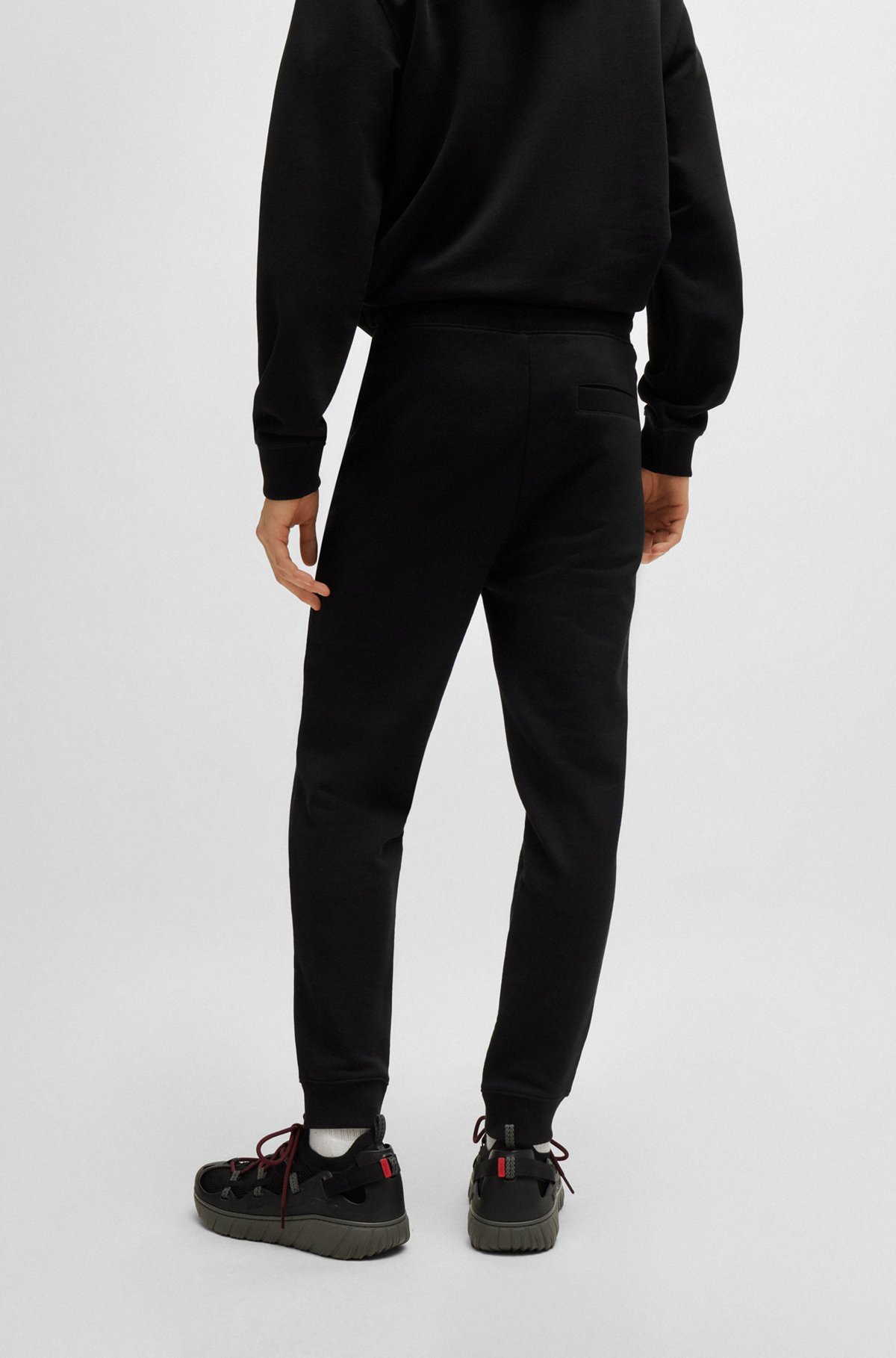 Cotton tracksuit bottoms with red logo patch, Black