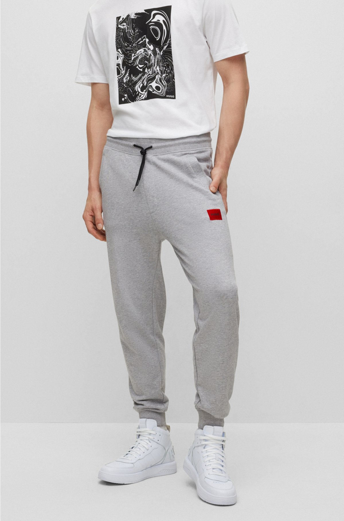 HUGO - Cotton-terry tracksuit bottoms with red logo label