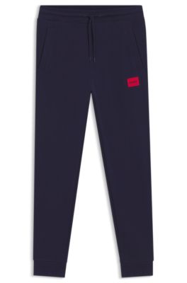 Pantalones de ch&aacute;ndal en felpa de algod&oacute;n con etiqueta con logo roja, Azul oscuro