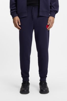 Pantalones de ch&aacute;ndal en felpa de algod&oacute;n con etiqueta con logo roja, Azul oscuro