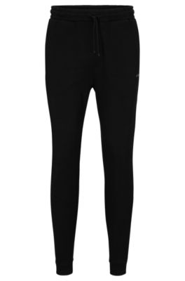 Shop Hugo Boss Cotton Tracksuit Bottoms With Curved Logo In Black