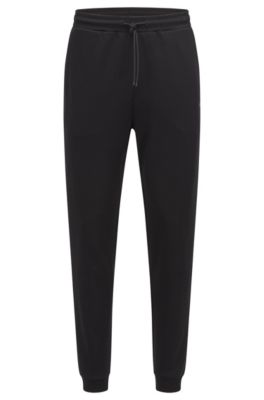 Shop Hugo Boss Cotton Tracksuit Bottoms With Curved Logo In Black