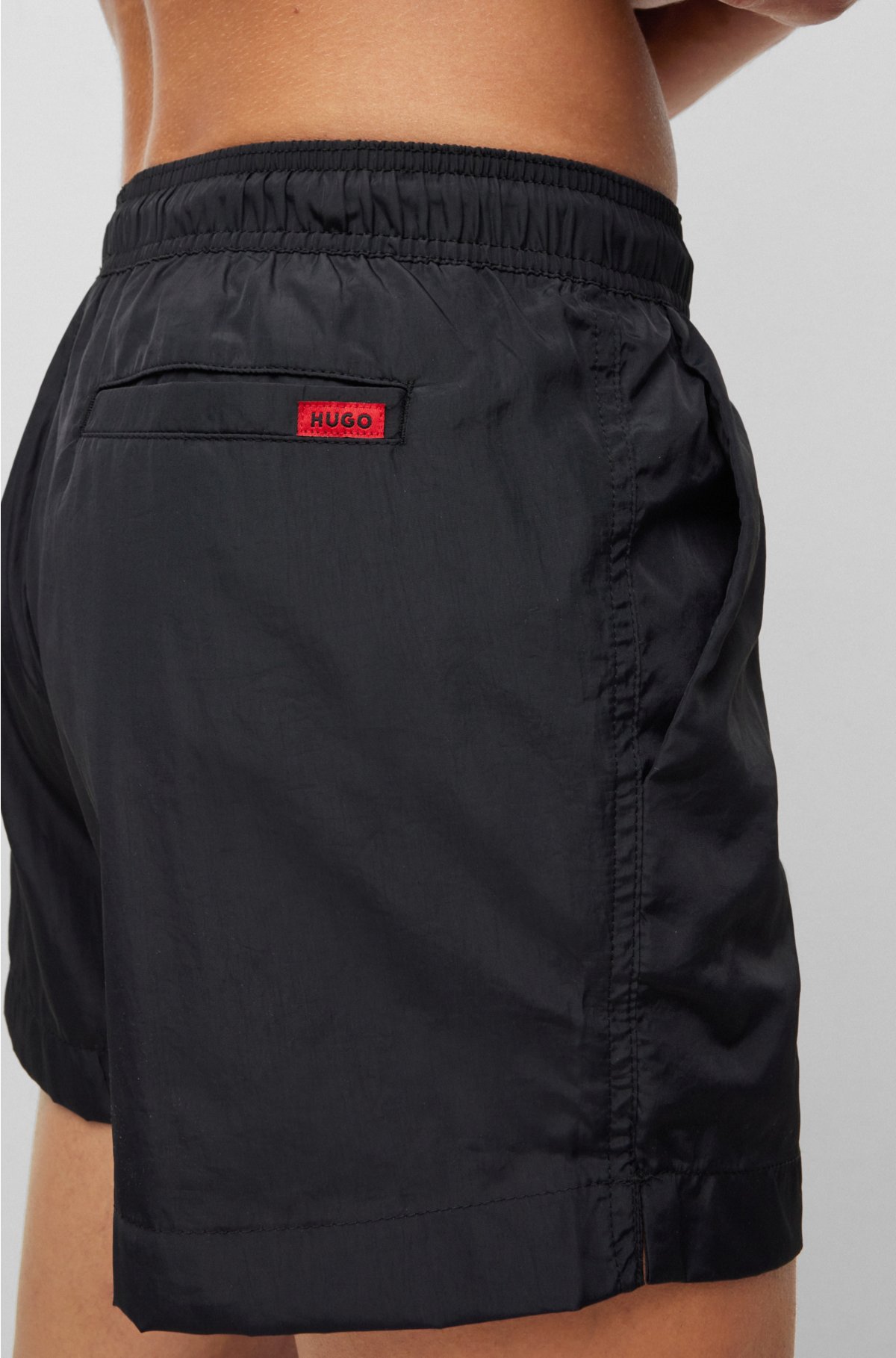 Quick-dry swim shorts with red logo label, Black