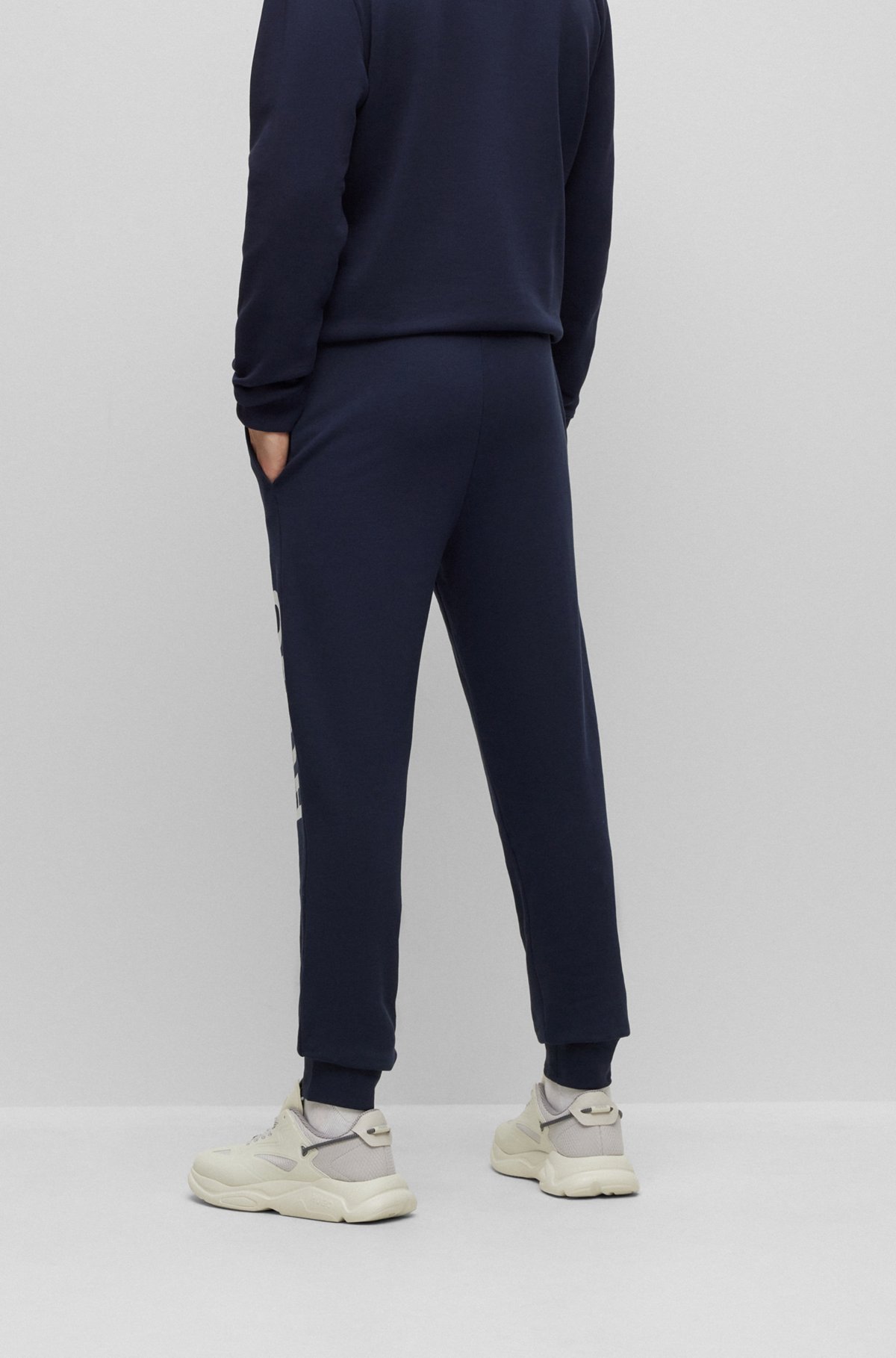 Cuffed tracksuit bottoms in French terry with contrast logo, Dark Blue