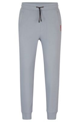 Pantalones de ch&aacute;ndal en felpa de algod&oacute;n con detalle de logo, Gris