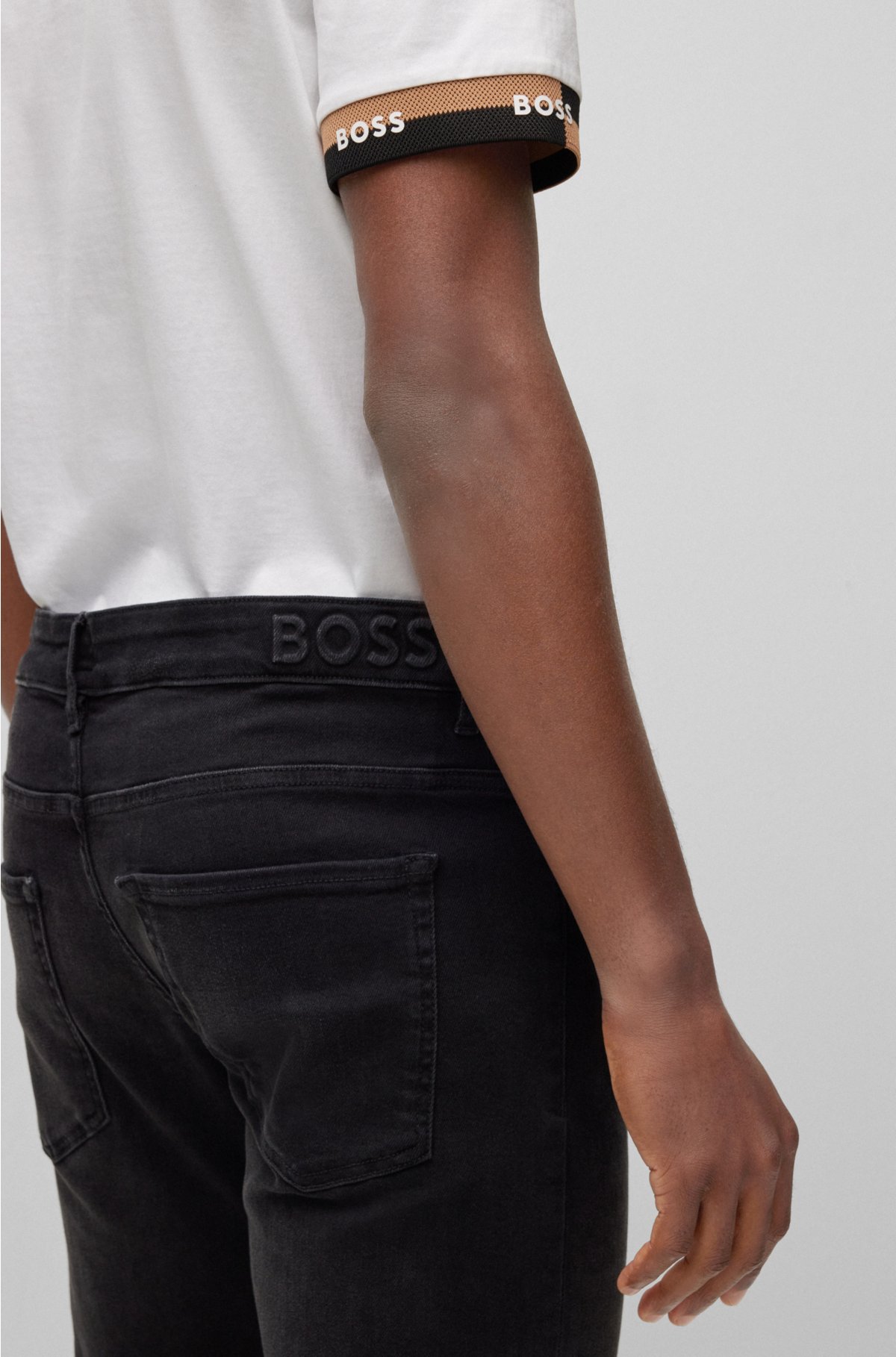 BOSS - Tapered-fit jeans in black supreme-movement denim