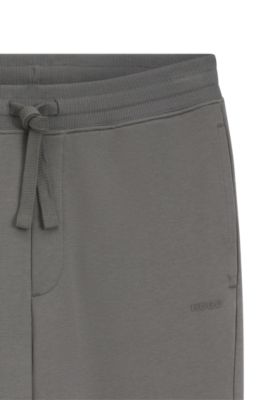 Bas de surv&ecirc;tement en molleton de coton avec logo imprim&eacute; et bas de jambes resserr&eacute;s, Gris sombre