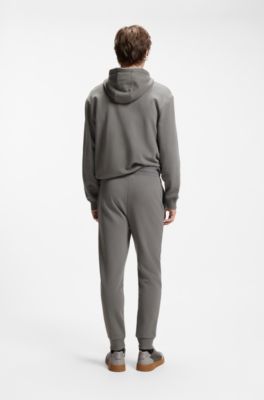 Pantalones de ch&aacute;ndal en felpa de algod&oacute;n con pu&ntilde;os y logo estampado, Gris oscuro