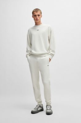 Pantalones de ch&aacute;ndal en felpa de algod&oacute;n con pu&ntilde;os y logo estampado, Blanco