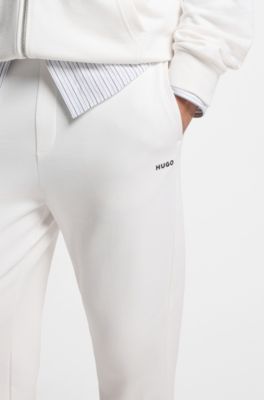 Pantalones de ch&aacute;ndal en felpa de algod&oacute;n con pu&ntilde;os y logo estampado, Blanco