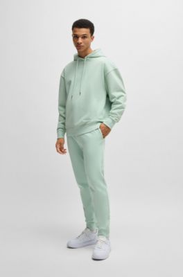 Pantalones de ch&aacute;ndal en felpa de algod&oacute;n con pu&ntilde;os y logo estampado, Cal