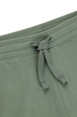 Pantalones de ch&aacute;ndal en felpa de algod&oacute;n con pu&ntilde;os y logo estampado, Cal