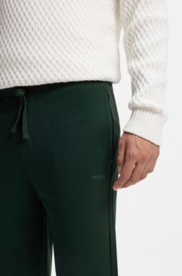 Pantalones de ch&aacute;ndal en felpa de algod&oacute;n con pu&ntilde;os y logo estampado, Cal