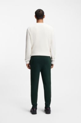 Pantalones de ch&aacute;ndal en felpa de algod&oacute;n con pu&ntilde;os y logo estampado, Cal