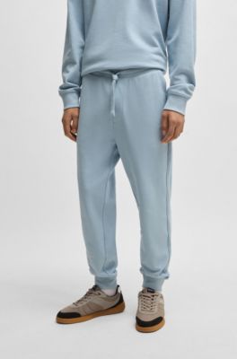 Pantalones de ch&aacute;ndal en felpa de algod&oacute;n con pu&ntilde;os y logo estampado, Celeste